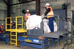Workers are Trained to Seal the Soft-Sided Packages that will be used for the Silo 3 Waste.
Workers will remove 5,100 cubic yards of low-level cold metal oxide waste from Silo 3. Waste from the production process was placed in the silo between 1952 and 1957. Workers will use pneumatic and mechanical retrieval systems to remove the waste from the silo and package it in soft-sided containers for off site shipment. The waste will be treated only as required to meet commercially permitted facility's waste acceptance criteria. 
Keywords: Fernald Closure Project Fernald Green Salt Plant, Feed Materials Production Center, Fernald, Ohio (FEMP)