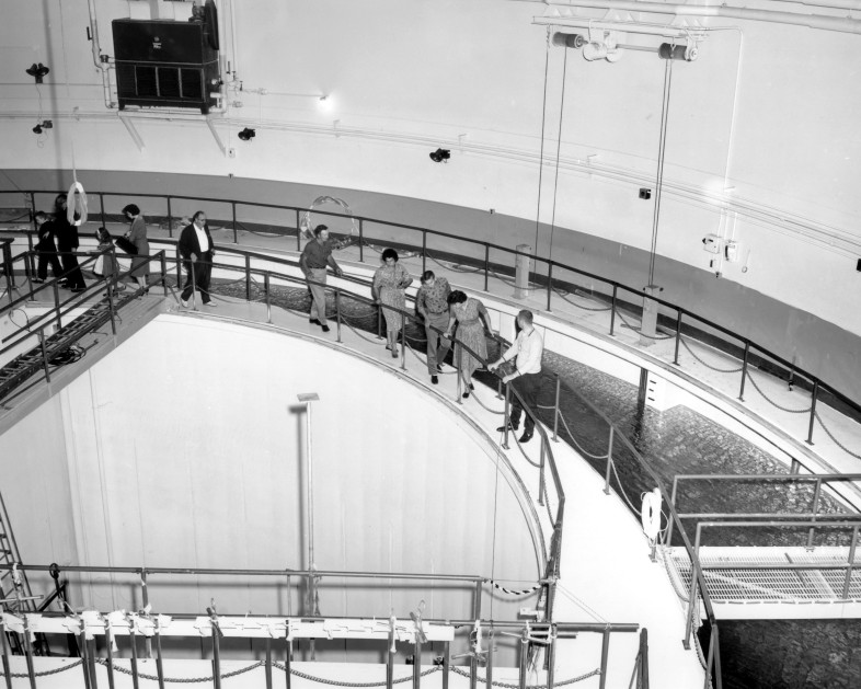 Reactor's pressure tank and core
A group tours the Plum Brook Reactor quadrant area in this late 1960's era photo. The group is standing on a catwalk above 25-to-27 foot- deep quadrants that surrounded the reactor's pressure tank and core. The quadrants were normally filled with water to provide shielding as the radioactive test materials were transported along the canal basin.
