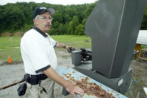 Firing range instructor for the Y-12
Steve Lynn, a firing range instructor for the Y-12 nuclear weapons plant in Oak Ridge, Tenn., points to the barrel of a gun mounted in a remote-controlled firing platform Friday, July 2, 2004. Y-12 guards have been training with the system, but Department of Energy officials won't say when they will be deployed.
Keywords: firing range instructor for the Y-12 nuclear weapons plant in Oak Ridge