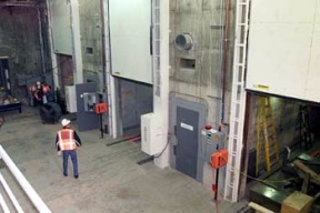 Work Continues in the Three Product Fill Rooms where the Casks will be Filled Robotically with the K-65 Stabilized Waste.
8,900 cubic yards of high activity low-level waste material will be removed from Silos 1 and 2, processed and shipped off site for disposal. This material was generated from 1951 to 1960 as a waste by-product from the processing of high-grade uranium ores. The Silos 1 and 2 material, also known as K-65 material, contains radium and thorium radionuclides. Waste Retrieval Project will consist of six major systems; Silos Waste Retrieval System; Decant Sump Waste Retrieval System; Transfer Tank Area; Transfer Tank Waste Retrieval System; Radon Control System; and the Full Scale Mock-up System. Once the waste is removed from the silos it will then be stabilized with a formulation of flyash and Portland cement before being containerized for shipment. 
Keywords: Fernald Closure Project Fernald Green Salt Plant, Feed Materials Production Center, Fernald, Ohio (FEMP)