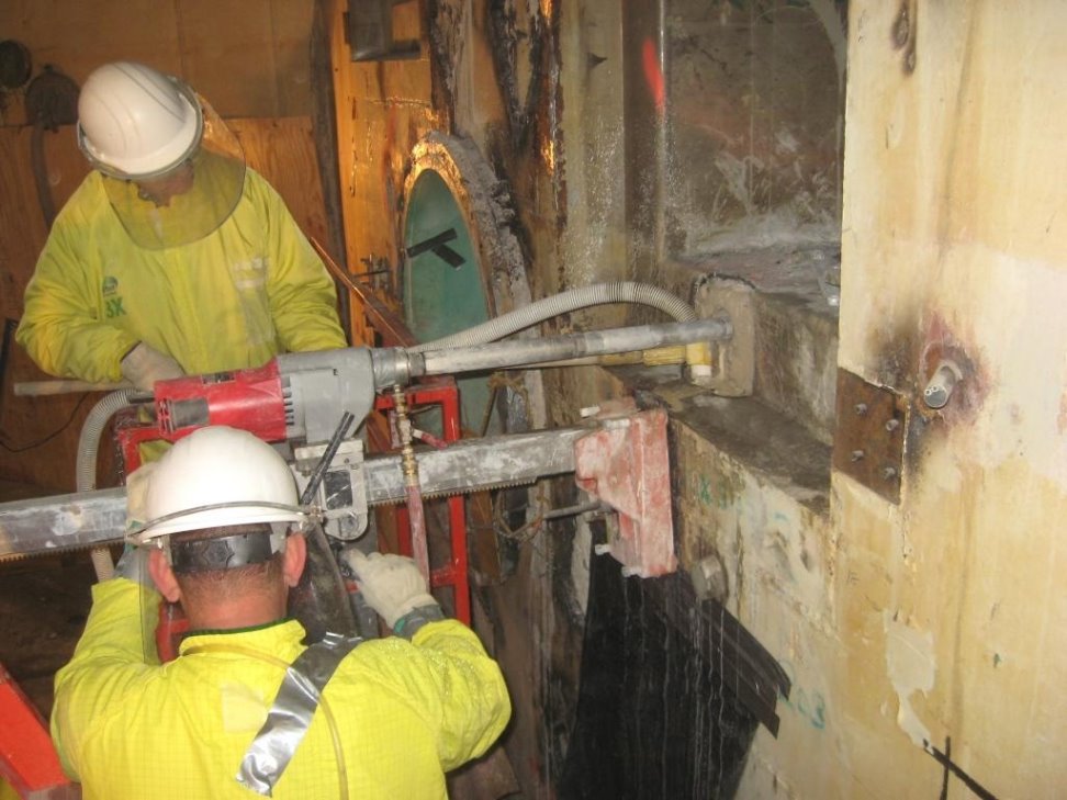 Workers drilled deep into the walls for diamond-wire cutting.
Workers drilled deep into the walls of the quadrant in order to set up the powerful diamond-wire saw for cutting through the bio-shield. 
