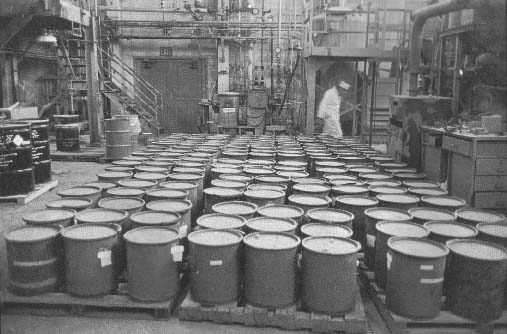 Uranium Green Salt
Ten-gallon drums of uranium green salt line the floor of the Fernald Green Salt Plant. Uranium green salt, the product of a long chain of chemical transformations, is the base element for the transformation of uranium into metal. Building 4, Feed Materials Production Center, Fernald, Ohio. December 16, 1985. 
Keywords: Fernald Green Salt Plant, Feed Materials Production Center, Fernald, Ohio (FEMP)