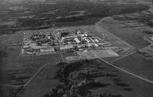 Fernald Feed Materials Production Center
Owner : United States Department of Energy Managing Contractor: Nation Lead of Ohio, 1951-1986. Westinghouse, 1986-
Area of plant: 136 acres; total site area: 1,050 acres
Structure: 9 plants, 73 buildings Employees: 1,000 
Principle product: Uranium metal forms: derbies, ingots, rods, and tubes for nuclear weapons factories

The Fernald facility is called a "feed materials production center" because it produces uranium materials which it feeds to the rest of the nuclear weapons complex. Fernald, 20 miles northwest of Cincinnati, Ohio. May 22, 1984.
Keywords: Fernald Green Salt Plant, Feed Materials Production Center, Fernald, Ohio (FEMP)