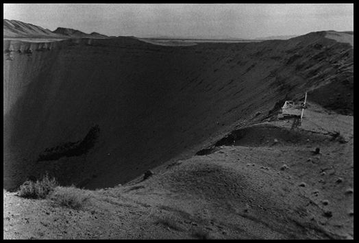 Sedan Crater
Detonation : 9:00A.M., July 6, 1962, Nevada Test Site
Yield: 110 kilotons (thermonuclear)
Crater: 600 feet deep, 1,200 feet wide, 179 million cubic feet in volume 
Purpose: Earth-moving experiment to determine the feasibility of national-crisis engineering projects, such as the creation of an alternate Panama Canal should the existing waterway become obstructed
Area 10, Nevada Test Site, Nye County, Nevada. October 29, 1984.
Keywords: Nevada Test Site, Mercury, Nye County, Nevada NTS