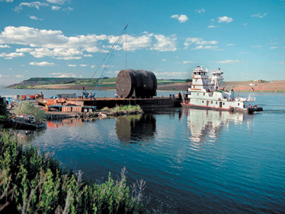 Defueled reactor components from nuclear-powered submarines and cruisers are barged to the Hanford Site and buried in a trench in the 200-East Area.
Keywords: Hanford Reservation, Richland, Washington