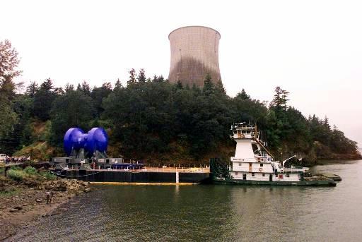 Trojan Nuclear Power Plant (decommissioned)
The Trojan Nuclear Power Plant reactor vessel, covered in blue shrink-wrap, slowly moves onto a barge on the Columbia River as the cooling tower stands in the background near Rainier, Ore., Friday, Aug. 6, 1999. The reactor vessel will travel by river to southeast Washington state over the weekend where it will be buried at Hanford Nuclear Reservation. Trojan was shut down in 1993.
Keywords: Trojan Nuclear Power Plant Rainier Ore (decommissioned)