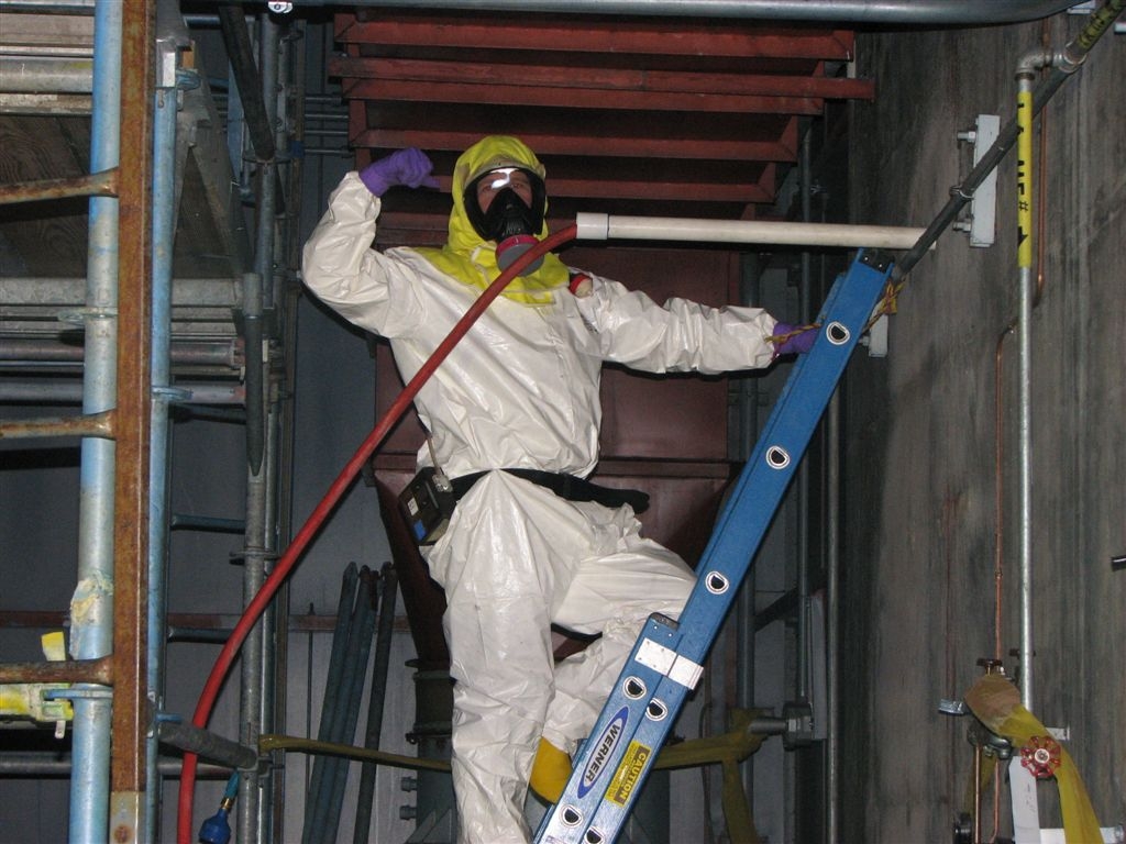 Dave Wells, Room 505
Dave applies fixatives to a vertical ventilation run by boring through 18" of concrete and inserting the hose.
