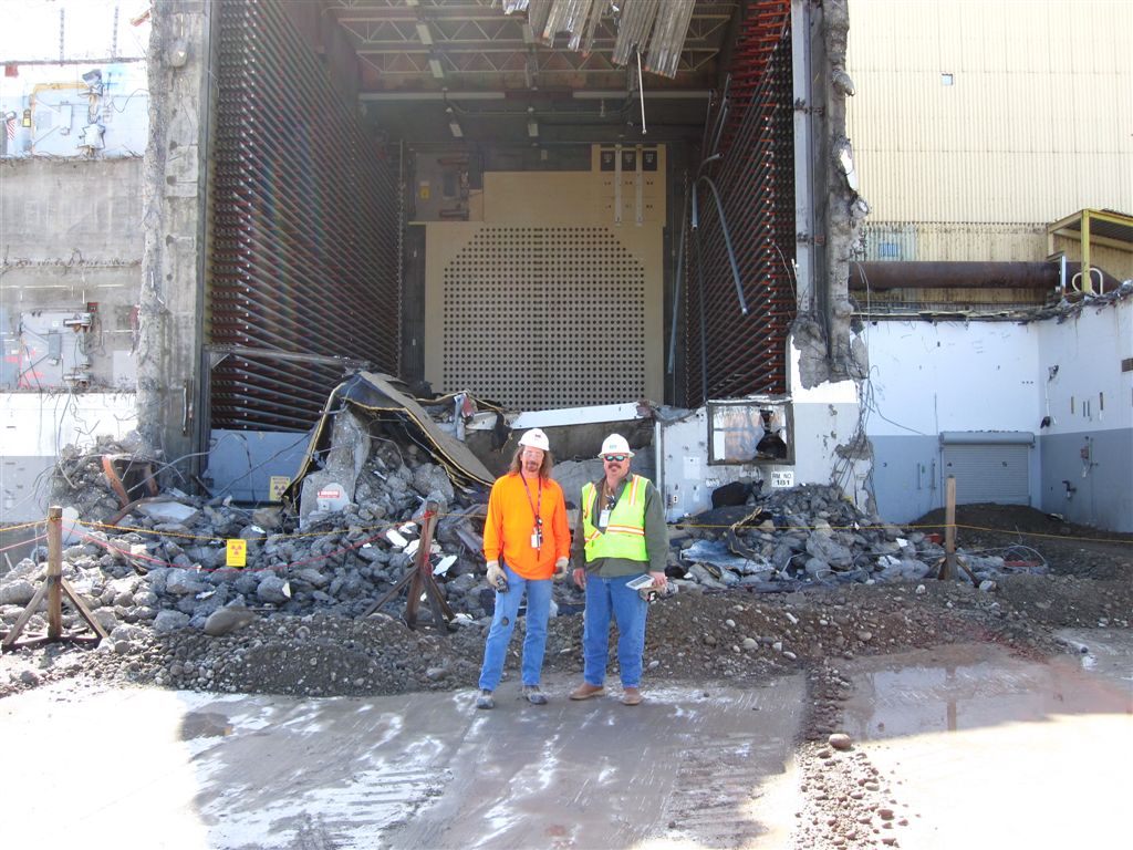 Eppling, Sims
Behind Greg and Mark, the demo advances.  
W elevator where the new fuel was loaded.  The pattern of ports on the wall corresponds to the front face of the reactor.
