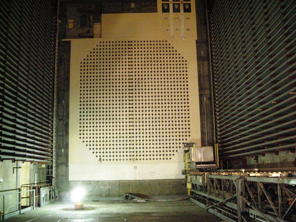 W Elevator, 105N Reactor
The array of penetrations corresponds to the front face of the reactor with it's somewhat more than 1000 horizonatal tubes, each containing about ten fuel elements.  Racks on either side (walls) hold steel tubes which would have been pre-loaded and using the equipment on the right in the picture, inserted through these penetrations for refueling.
