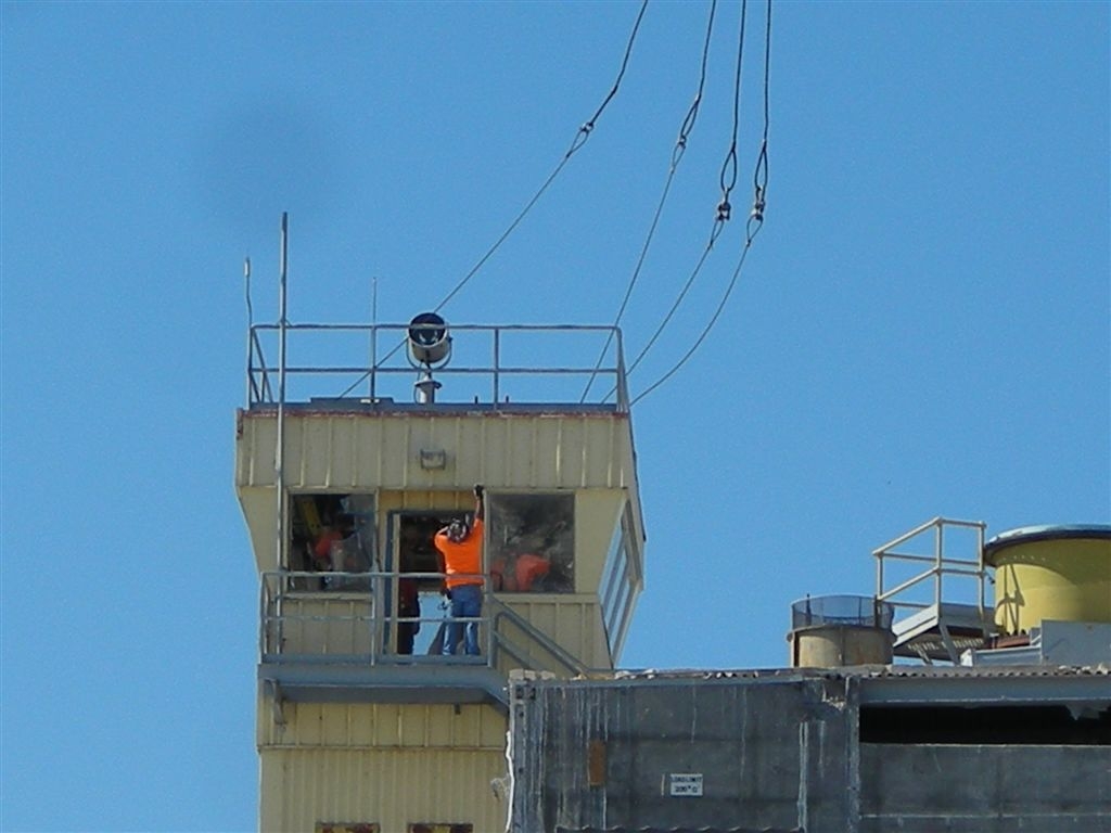 Preparing for the lift
105N Security's Tower is attached to the rigging cables for it's lift from the roof.
