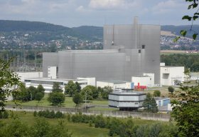 Wuergassen grey reactor building behind trees